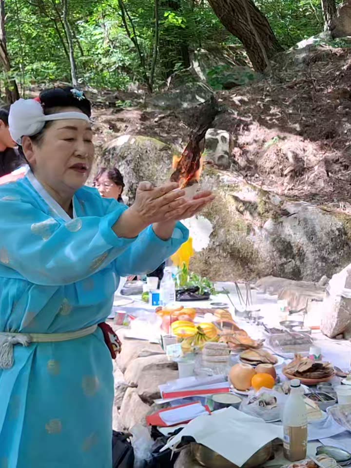 A shaman offering a prayer at a forest altar