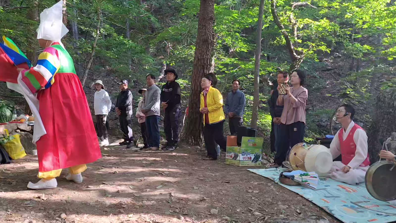 A shaman in red dancing in the forest